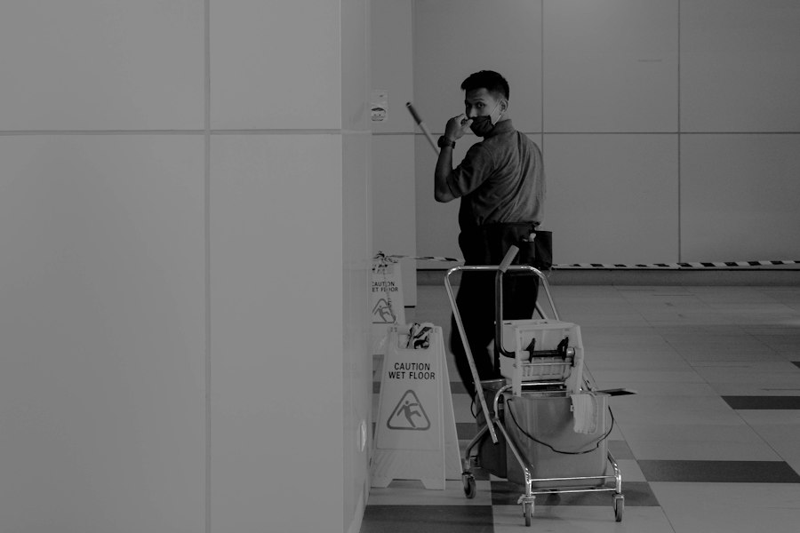 Cleaning professional with a service cart in a commercial building