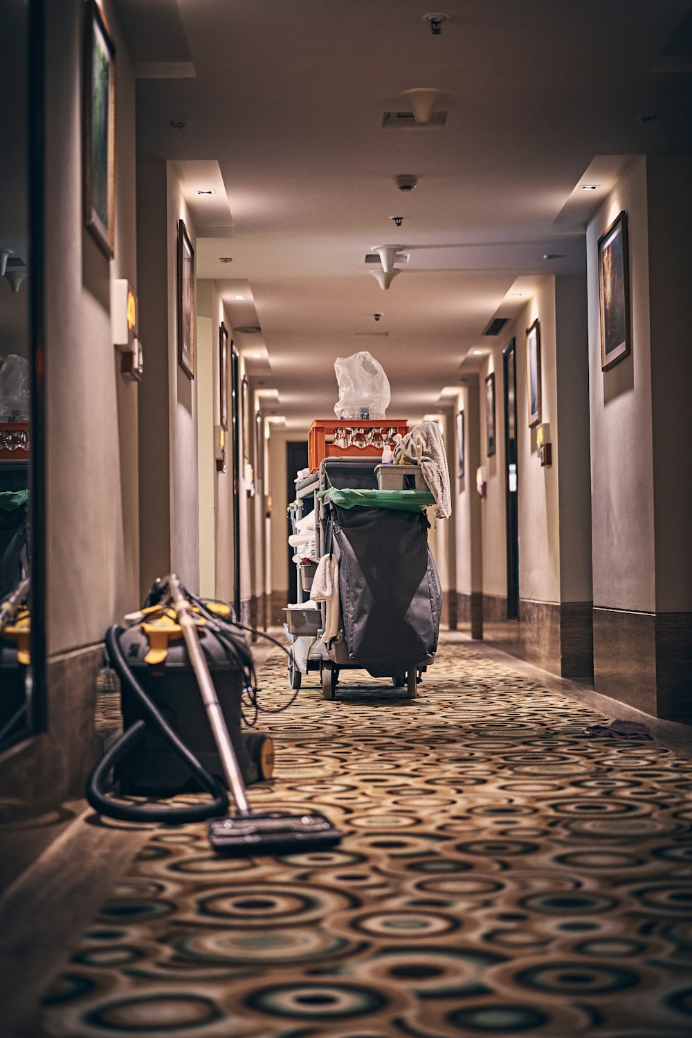 Janitorial cart and vacuum in a commercial corridor